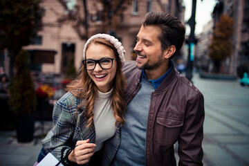 Excited couple enjoying a city shopping spree