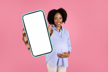 African Pregnant Lady Demonstrating Big Smartphone Screen In Pink Studio