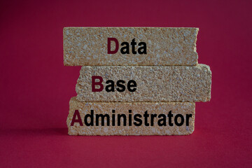 Data Base Administrator symbol. DBA acronym on brick blocks with letters. Beautiful red background. Data Base Administrator or doing business as abbreviation DBA concept
