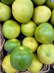 pomelo in a store in a basket