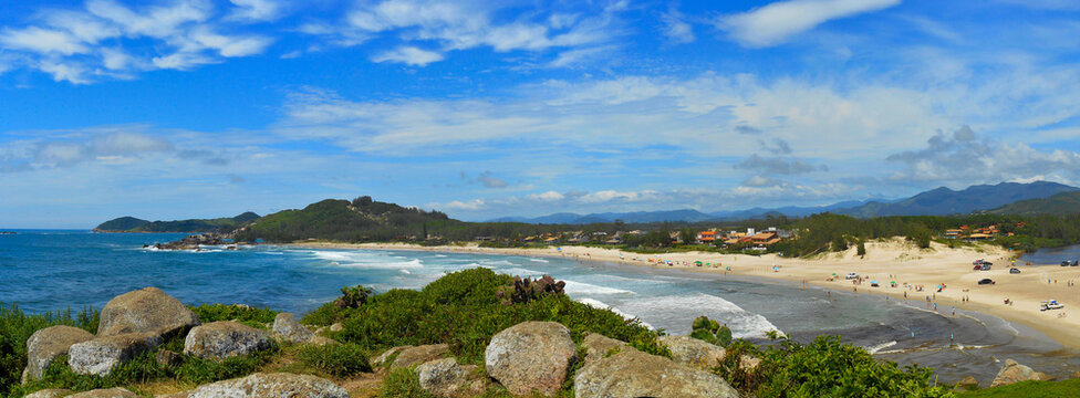 landscape withPanoramic view of Barra Garopaba beach, with rocks at the top of the viewpoint in the foreground. lake