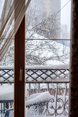 Snowy balcony. First snow. Outside the window