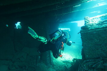 Scuba diver inside the wreck of the Chrisoula K in the Red Sea in Egypt - obrazy, fototapety, plakaty