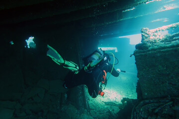 Naklejka na ściany i meble Scuba diver inside the wreck of the Chrisoula K in the Red Sea in Egypt