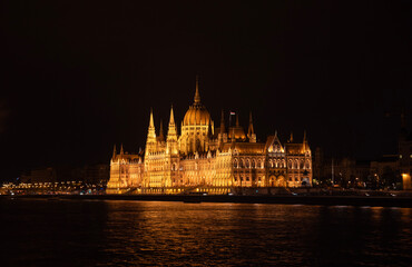 Naklejka premium Night shot of the Parliament building in Budapest. Hungary. The building of the Hungarian Parliament is located on the banks of the Danube River, in the center of Budapest.