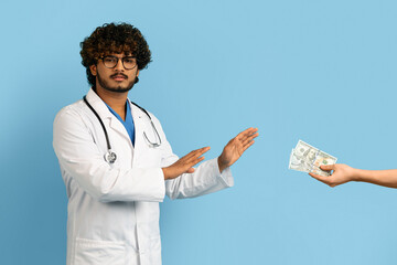 Annoyed angry doctor refusing to take bribe