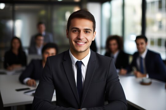 The Happy Young Businessman Joins A Meeting With His Team.