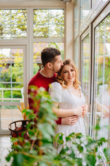 Man and woman at the window of a country house