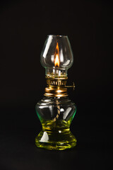 An antique oil lamp, symbolizing Diwali's essence, illuminated against a dark background. Perfect...
