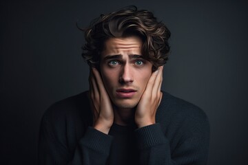 Fototapeta premium young man posing in the studio with an expression of surprise and worry