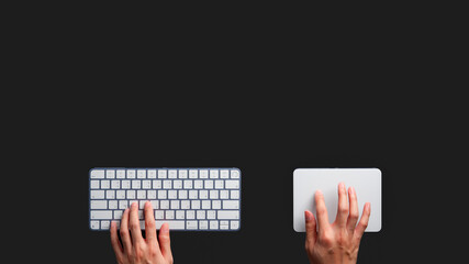 A student uses a keyboard and trackpad to search for information. An employee uses a keyboard and trackpad to do work. An image of a hand using a keyboard and trackpad on a black background.