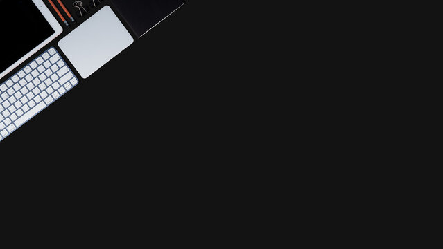 Office equipment is placed on the black table, arranged in an orderly, Office equipment background image, diagonal orientation.