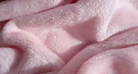 Light pink fleece fabric. Polyester. Pile fabric. Fabric texture. Fleece.