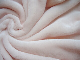 Light pink fleece fabric. Polyester. Pile fabric. Fabric texture. Fleece.