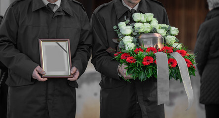 Metal urn or funeral container with ash of a deceased person at a memorial service. Undertakers...