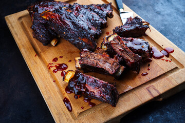 Traditional barbecue burnt chuck beef ribs marinated with spicy rub and served as close-up on a...
