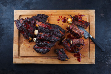 Traditional barbecue burnt chuck beef ribs marinated with spicy rub and served as top view on a...