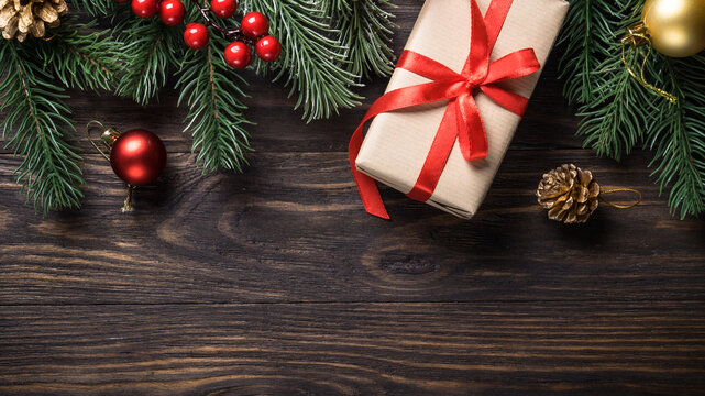 Christmas presents and holiday decorations on wooden background. Flat lay image.