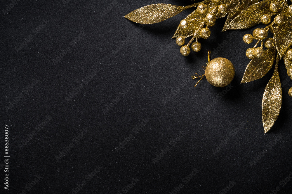 Wall mural Christmas gold decorations on black. Flat lay image with copy space.