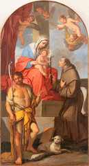 Obraz na płótnie Canvas VICENZA, ITALY - NOVEMBER 5, 2023: The painting of Madonna with the st. John the Baptist and St. Anthony of Padua by Giulio Carpioni (1650).