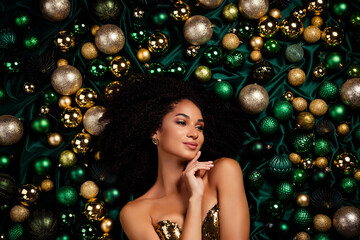 High angle top view portrait of attractive model lady lying among xmas event golden tree shiny...