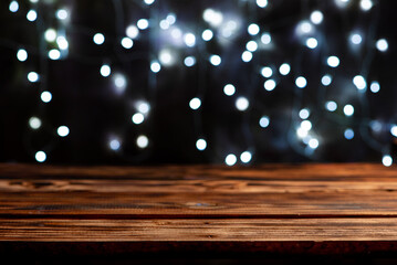 Rustic wooden table, Empty rustic wooden table with blurred Christmas lights in the background,...