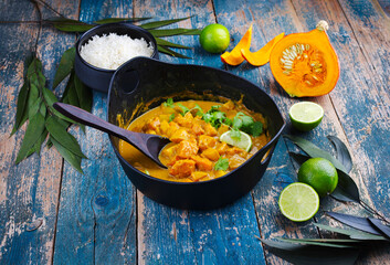 Traditional Indian vegetarian curry stew with sweet potatoes, pumpkin and rice served as close-up in saucepan
