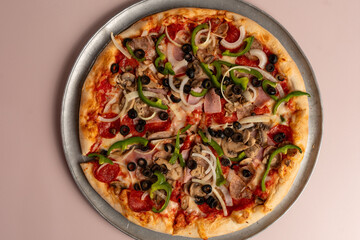 Meat lovers pizza with green peppers and olives