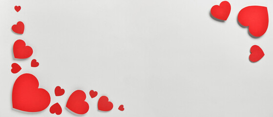 Romantic composition with red paper hearts on white background. St. Valentine's Day.