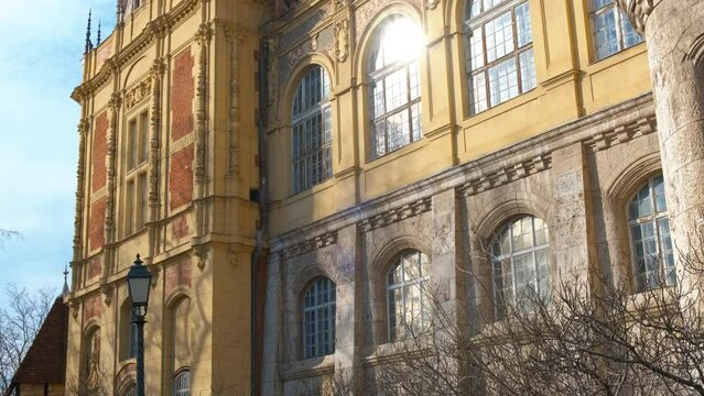 Sunny ancient facade of castle in budapest. A view of historical Vajdahunyad castle facade in the suny park.