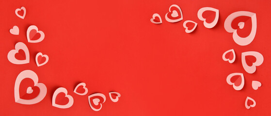 Many paper hearts on red background with space for text. Valentine's Day celebration