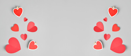 Red paper hearts on grey background with space for text. Valentine's Day celebration