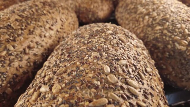 Homemade bread with seeds on bakery display shelf window