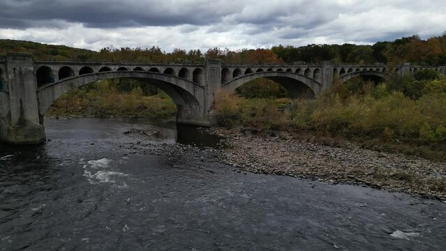 water flowing under the delaware river viaduct between portland, pa and columbia, nj (old abandoned railway bridge part of the lackawanna cutoff rail line) water gap landmark in fall, autumn