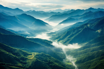 A lush mountain range photographed from above, showcasing the majestic peaks, valleys, and winding rivers.