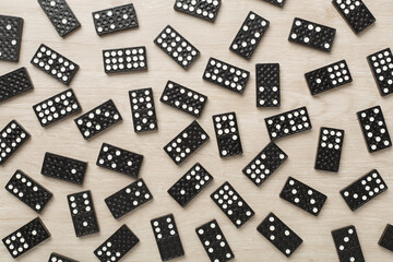 Black domino tiles on wooden background, top view