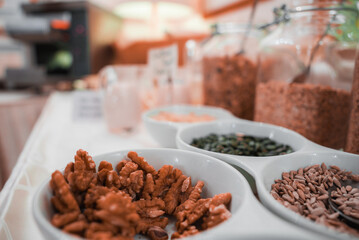 A close-up shot of a bowl of assorted nuts and seeds on a table, showcasing the interior of Venetian hotels and restaurants during the summer in Venice, Italy.