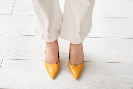 Woman in stylish high heeled shoes in shop