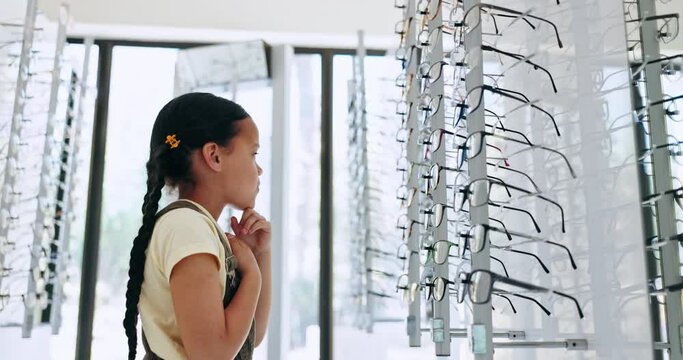Optometry, store and girl with options, decision and retail with clear vision, prescription lenses and choose. Person, kid and child with eyewear, shopping and customer with thinking, frame or client