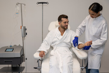 Fototapeta premium Man in modern wellness center during intravenous vitamin therapy.