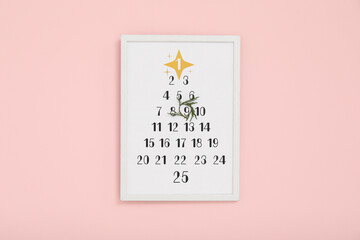 Christmas calendar on pink wall