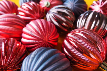 Multi-colored glass shiny balls. New Year's Christmas decoration. Festive design. Red, blue and brown striped balls. Christmas and New years eve Background. Close up of red Christmas ball ornaments.