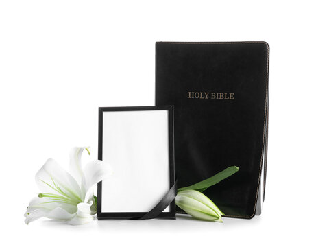 Blank photo frame with lily flower and Bible on white background