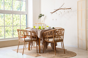 Autumn table setting decorated for Thanksgiving Day with pumpkins and chestnuts in light dining room