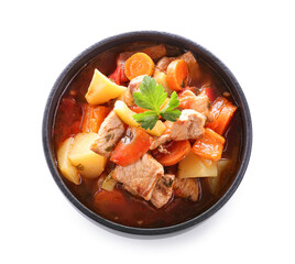 Black bowl with delicious beef stew and parsley on white background
