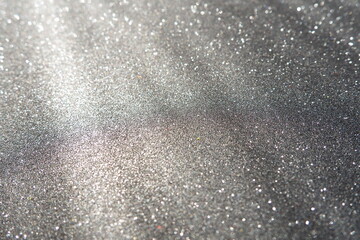 Oblique rays of light on a black surface. Bokeh, dust particles, reflection and magical glow....