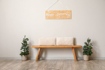 Interior of living room with wooden bench and Christmas trees