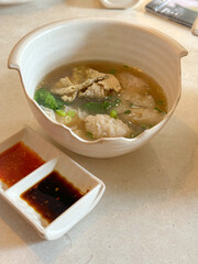 dumpling and fish soup in bowl
