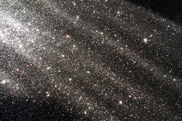 Oblique rays of light on a black surface. Bokeh, dust particles, reflection and magical glow....