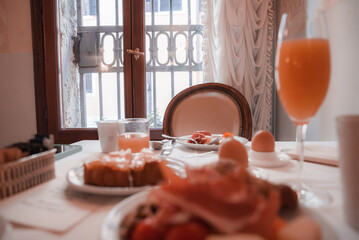 Enjoy a traditional Italian breakfast in Venice, Italy with a glass of orange juice and a plate of food. Experience the local cuisine and culture.